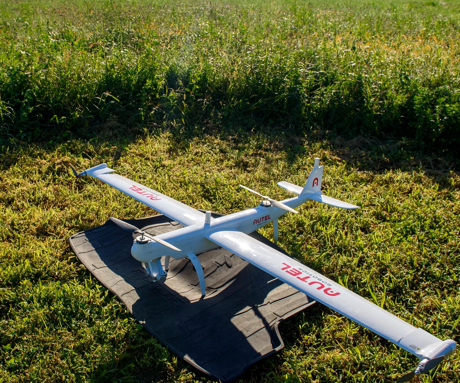 A large drone parked in a field